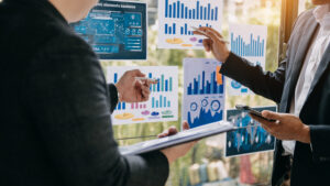 Business professionals analyzing marketing data dashboards and charts to optimize performance and customer insights