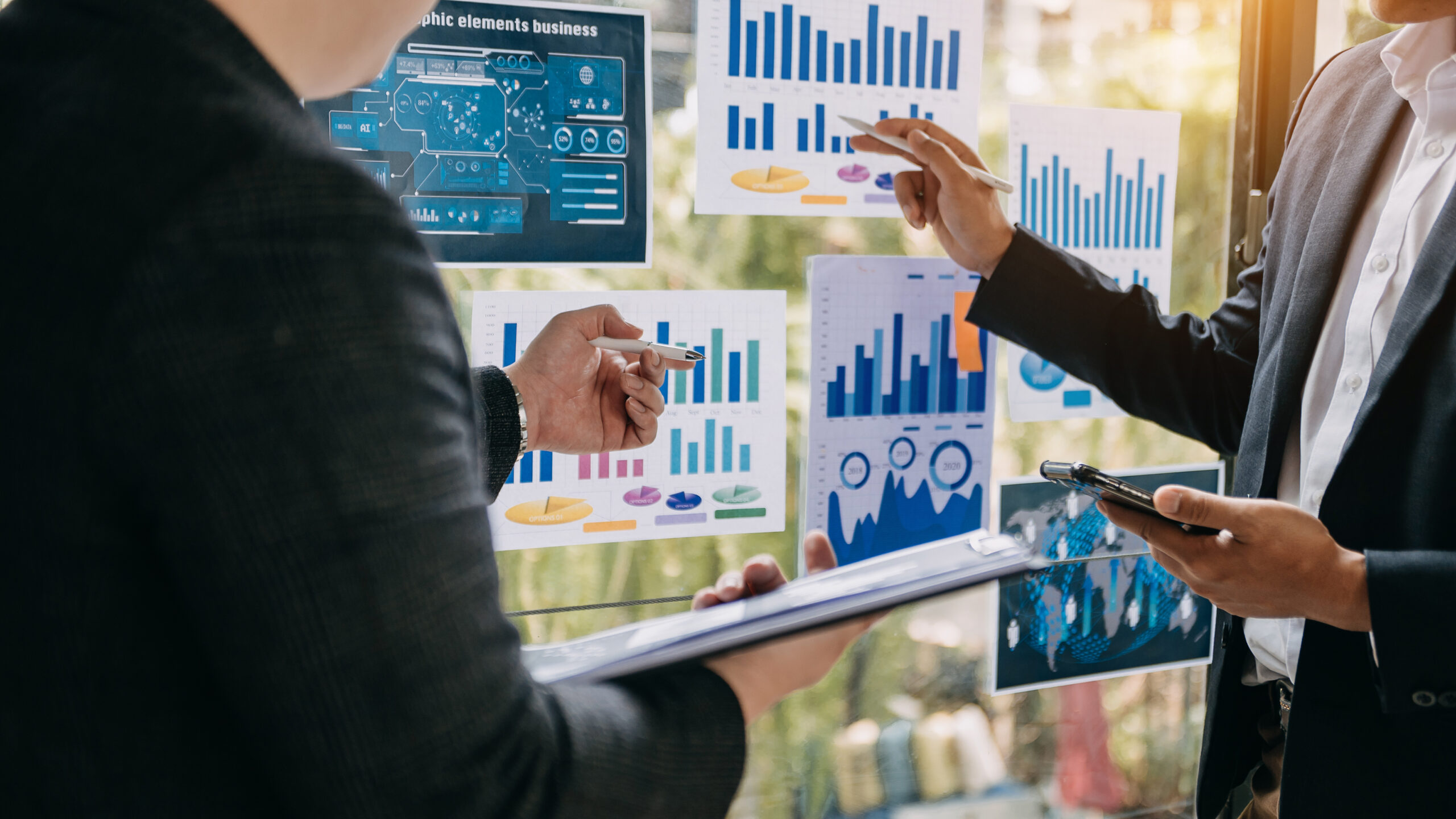 Business professionals analyzing marketing data dashboards and charts to optimize performance and customer insights