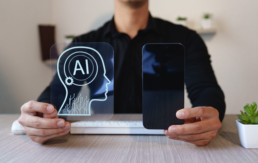 Person holding a transparent artificial intelligence (AI) symbol and a smartphone, representing human interaction with AI technology.